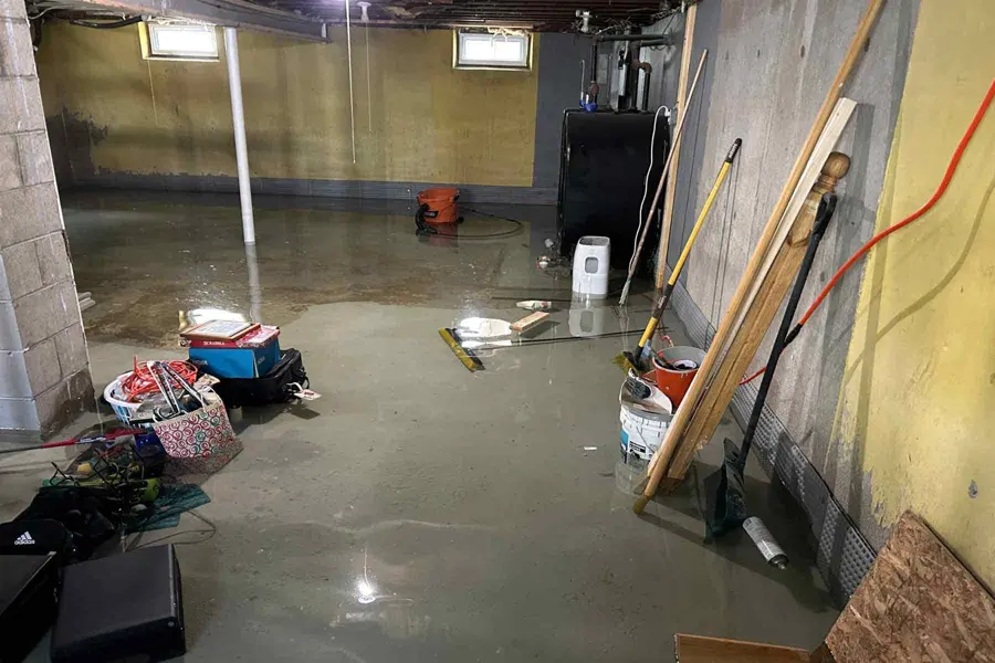 Flooded basement being pumped out in a Des Plaines, IL home